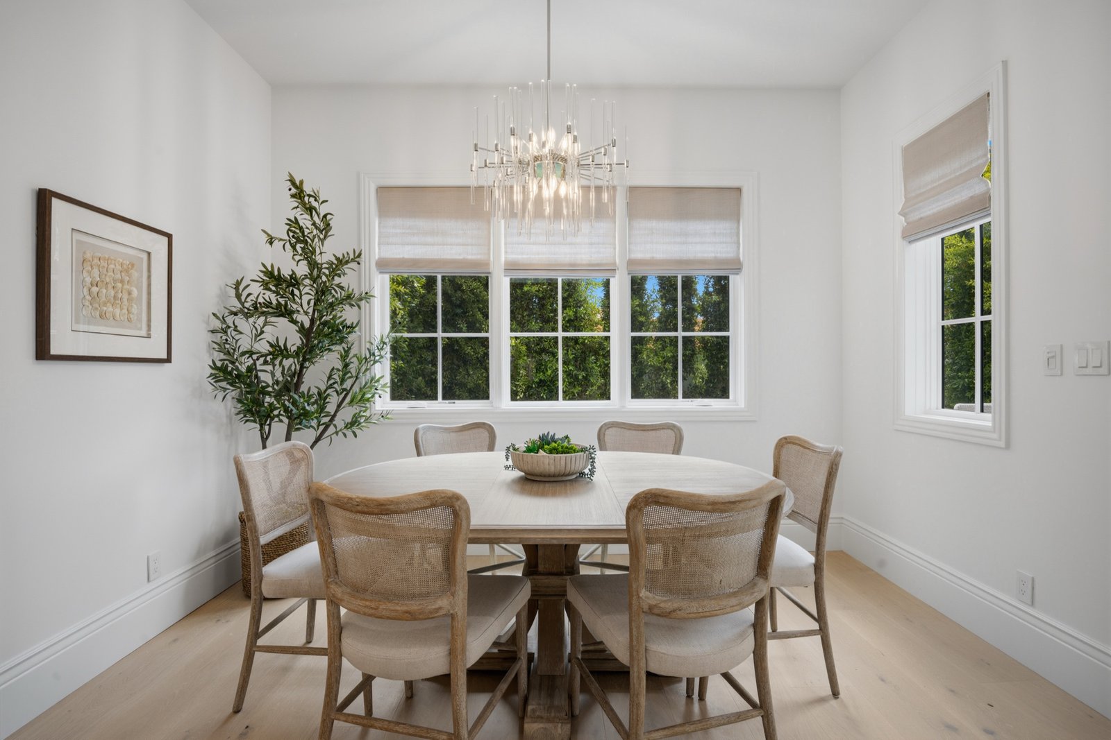 Dining room with round oak table and glass chandelier at 858 Fiske